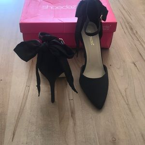 Black satin bow pumps
